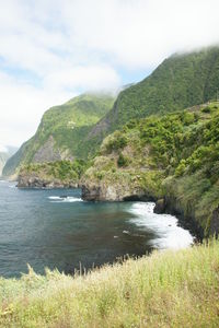 Scenic view of sea and mountains against sky