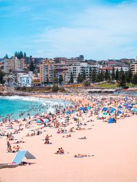 People at beach against sky