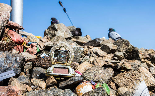 Stack of rocks against clear blue sky