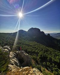 Scenic view of mountains against bright sun