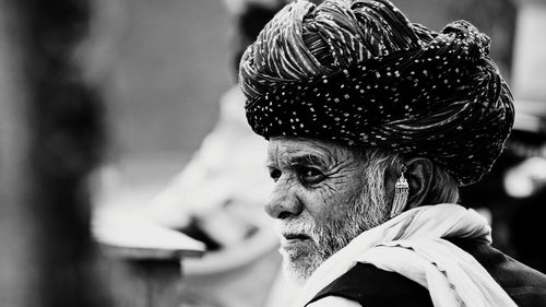 Close-up of man wearing turban looking away