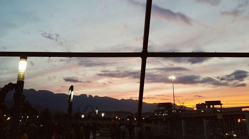 Silhouette city against sky during sunset