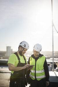 Workers looking at cell phone