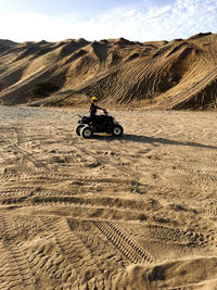 Man riding motorcycle on desert