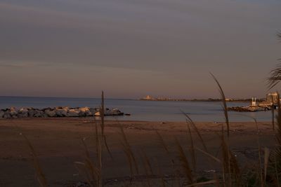 Scenic view of beach against sky during sunset