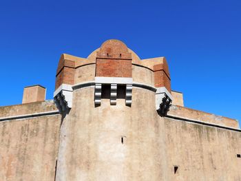 Low angle view of building against blue sky