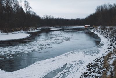 Scenic view of frozen lake against sky