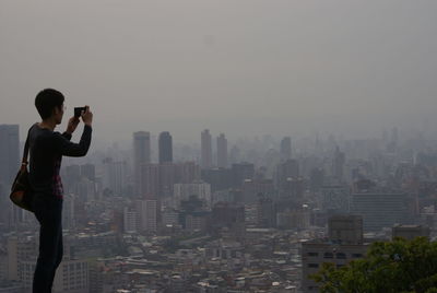 Woman photographing cityscape