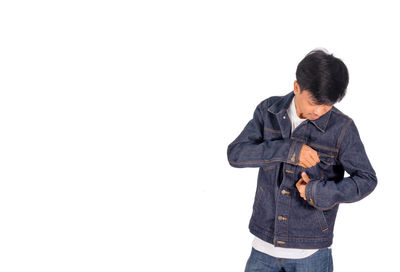 Full length of boy standing against white background