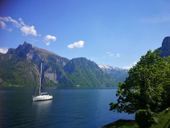 Scenic view of sea and mountains against sky