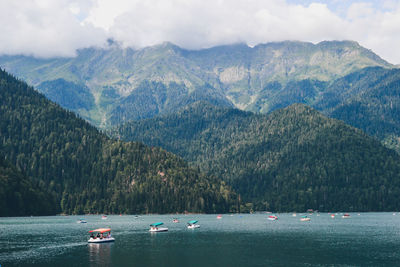 Scenic view of lake by mountains against sky