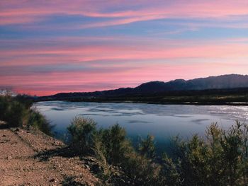 Scenic view of lake against sky during sunset