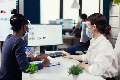 Side view of doctor working in office