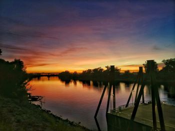 Scenic view of lake against orange sky