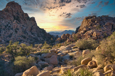 Scenic view of rocks against sky during sunset