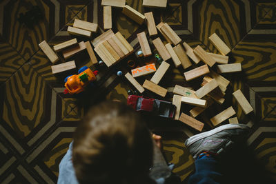 High angle view of boy playing with toys at home