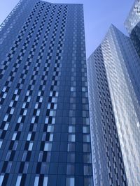 Low angle view of modern building against clear blue sky