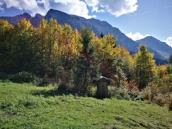 Scenic view of green landscape and mountains against sky