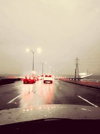 Cars on road against sky