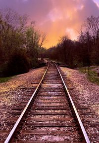 Railroad track against cloudy sky