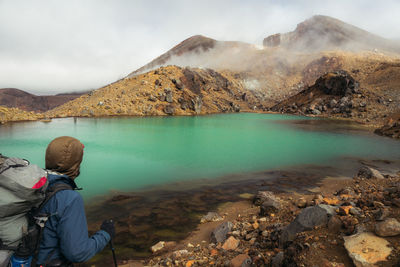 Rear view of man looking at lake