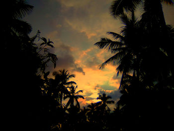 Low angle view of silhouette trees against romantic sky