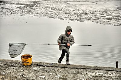 Full length of man fishing on sea