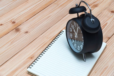 High angle view of clock on table