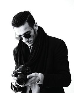 Man wearing sunglasses against white background