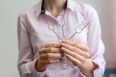 Midsection of woman holding plant