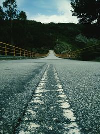 Road amidst trees against sky