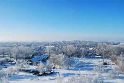 Aerial view of frozen landscape against clear blue sky