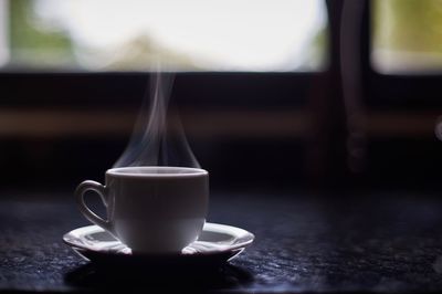 Close-up of coffee cup on table
