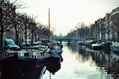 Boats in river with buildings in background