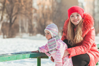 Portrait of smiling girl wearing hat during winter