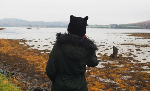 Rear view of tourist on lakeshore