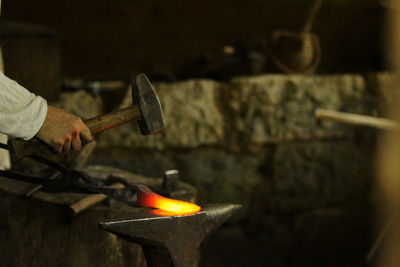 Cropped hand of carving making metal