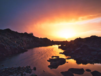 Scenic view of sea against romantic sky at sunset