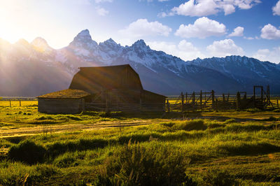 Scenic view of field and mountains against sky