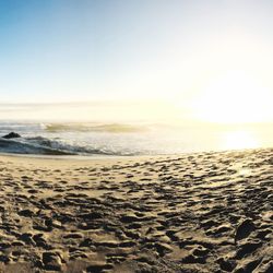 Scenic view of beach against sky during sunset