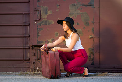 Full length of woman sitting at entrance