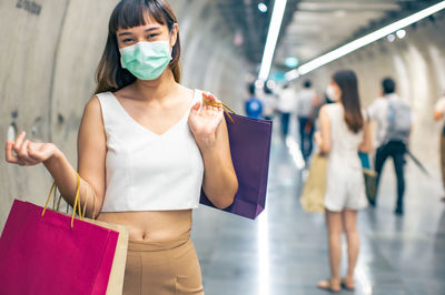 Midsection of woman holding while standing outdoors