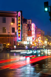 Illuminated city street at night