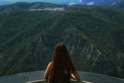 Rear view of woman looking in front of mountains