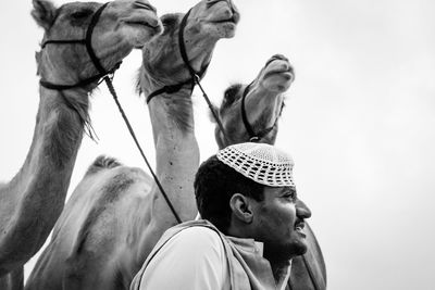 Low angle view of man standing against sky