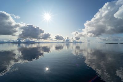 Scenic view of lake against sky on sunny day