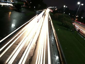 Illuminated railroad tracks at night