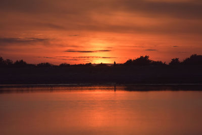 Scenic view of lake against romantic sky at sunset