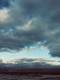 Scenic view of sea against storm clouds