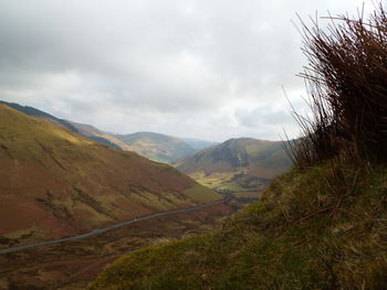 Scenic view of landscape against cloudy sky